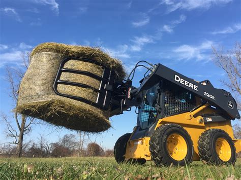 moving hay with skid steer|round hay bales for sale.